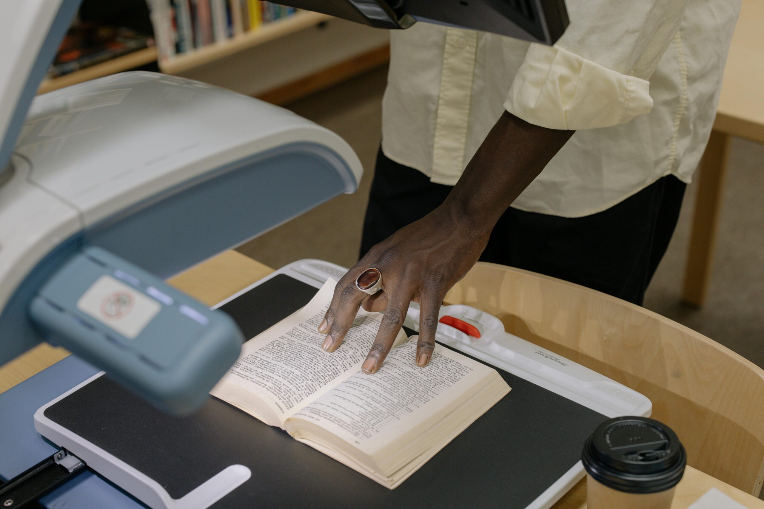 Person in white button up shirt holding white printer paper