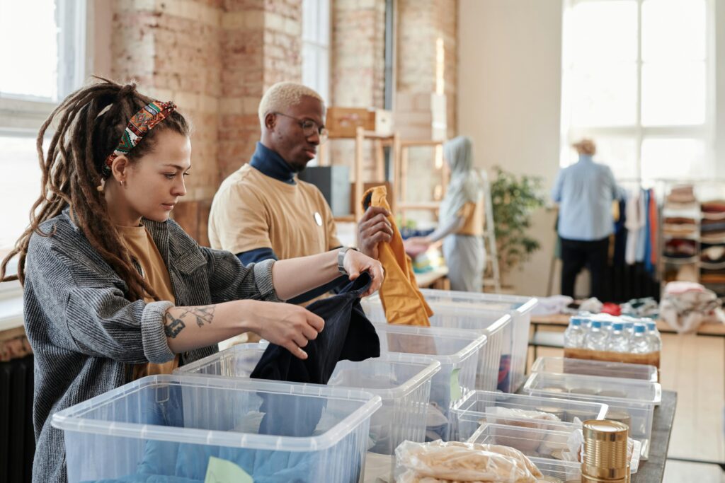 Woman with dreadlocks sorting clothes